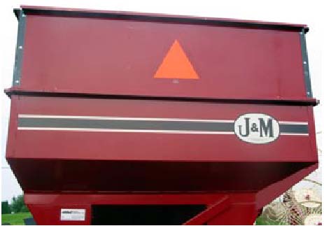 Photo 1: A properly placed SMV emblem that is clean, bright, and not obstructed. The red-orange fluorescent equilateral triangle should be the most obvious feature of the emblem