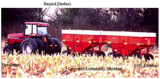 Tractor with hazard flashers, headlamp, extremity conspicuity markings, and smv emblem