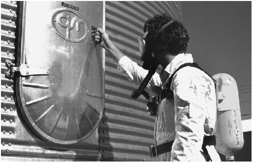 Man entering silo with respiratory gear