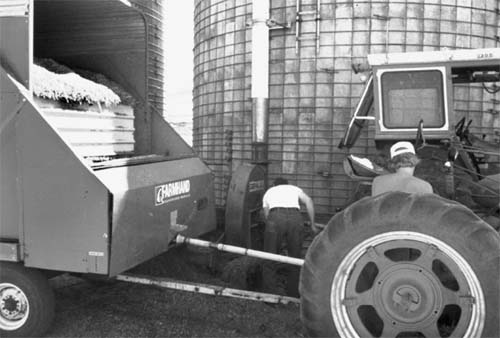 farmers working around a silo