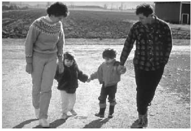 family holding hands while walking