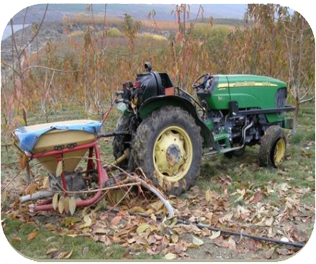 Photo of tractor with spreader.