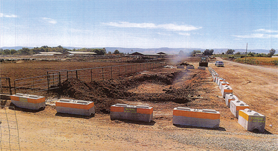 Storage of manure with solid barriers encircling