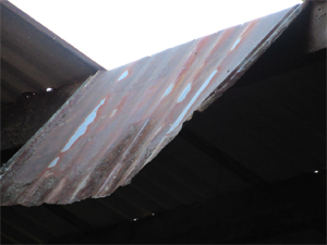 Close up of the corrugated metal part of the roof that came loose.