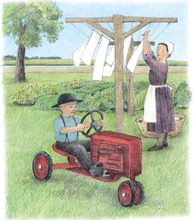 child driving toy tractor while mom hangs clothes