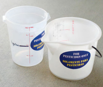 Marked measuring cups for pesticide use