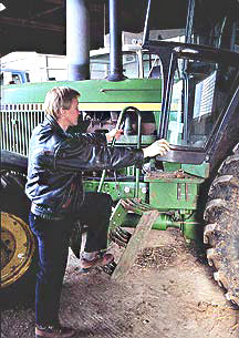 man mounting a tractor