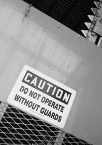 Caution sign on a machine- do not operate without guards